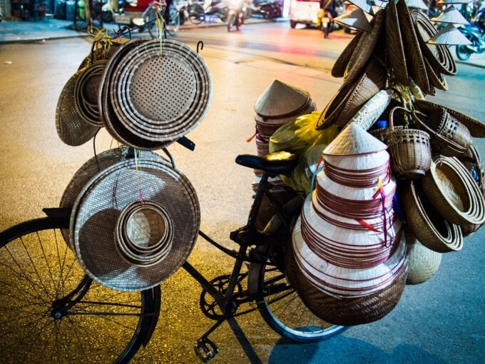 bicycle loaded with vietnamese hats in hanoi
