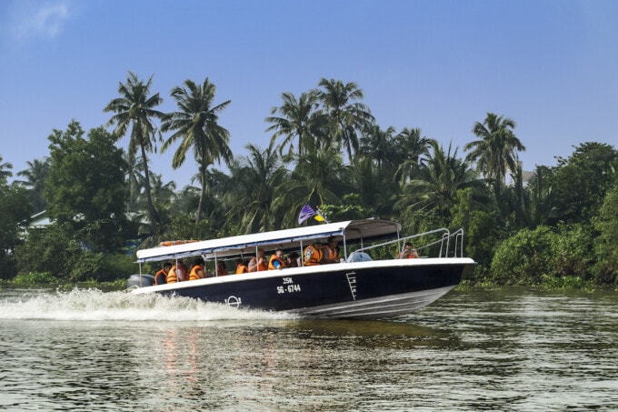 speedboat cruising along the mekong river