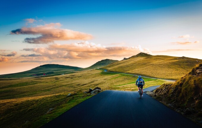 man on bicycle in empty landscape ecotravel